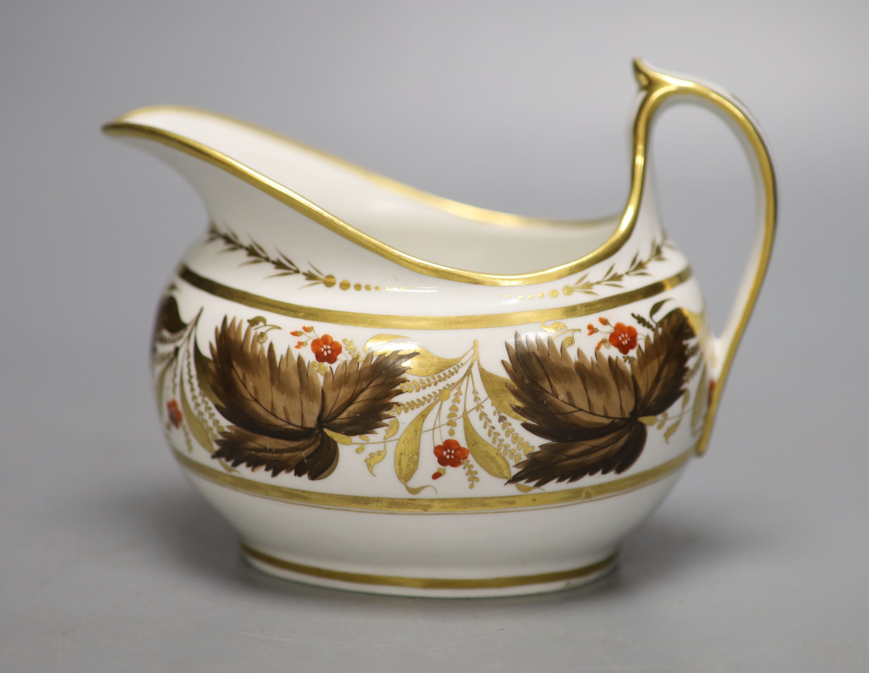 A Flight Barr and Barr cream jug painted with brown leaves and red flowers, height 11.5cm